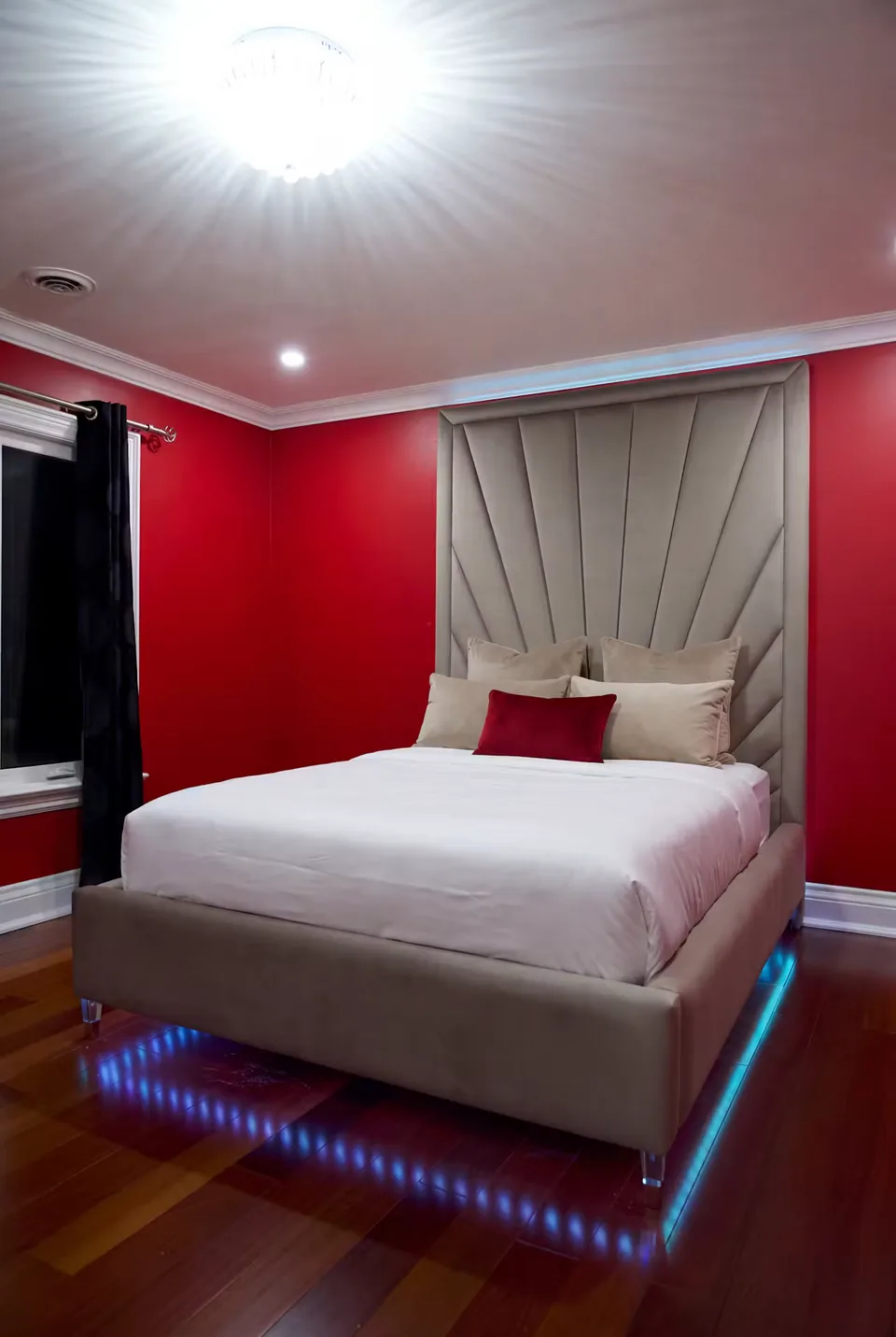 Angled view of the pale bed with blue accent lighting beneath the frame