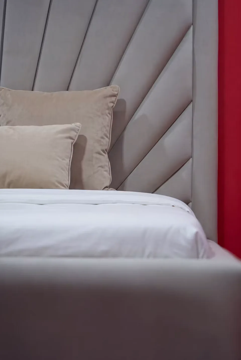 Detail of the sand-coloured radiating upholstery beside the pillows