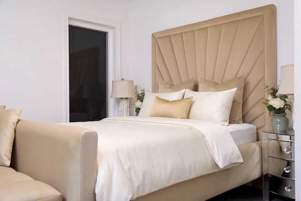 Angled view of the matching bed beneath the bordered upholstered fan