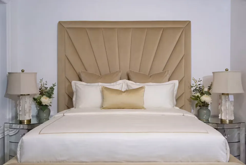 Wide front view of the sand fan headboard above the pillows