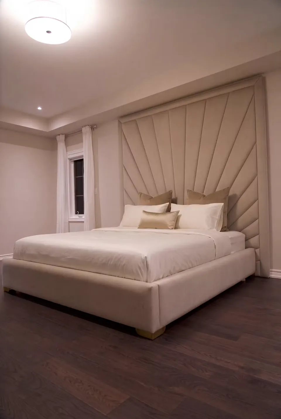 Angled view of the pale padded frame on a dark wood floor