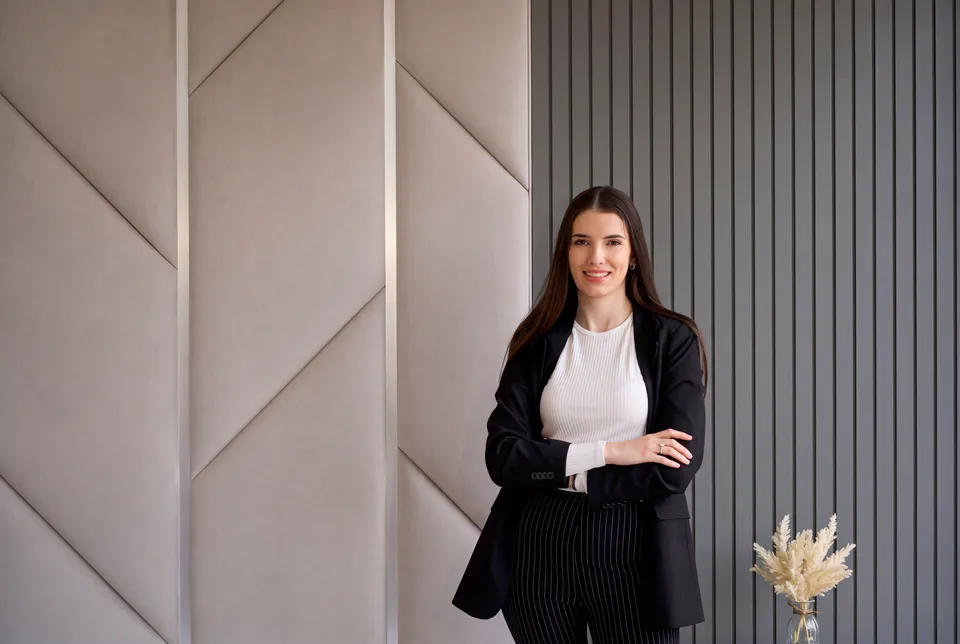 Danijela in the BOKO Designs showroom, in front of upholstered wall panels