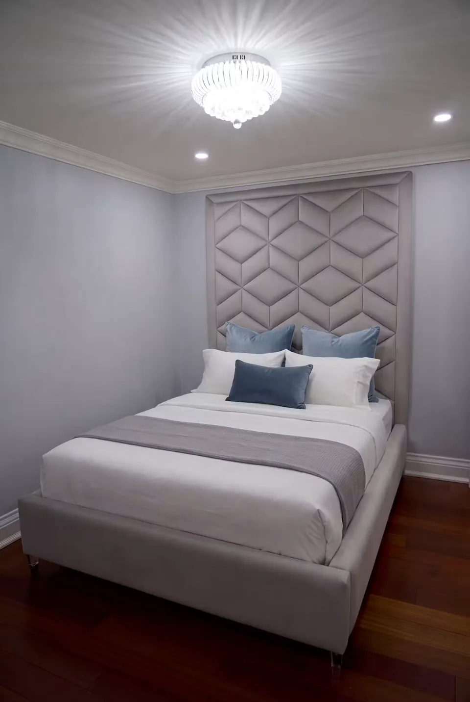 Full view of the grey frame beneath the diamond-pattern headboard