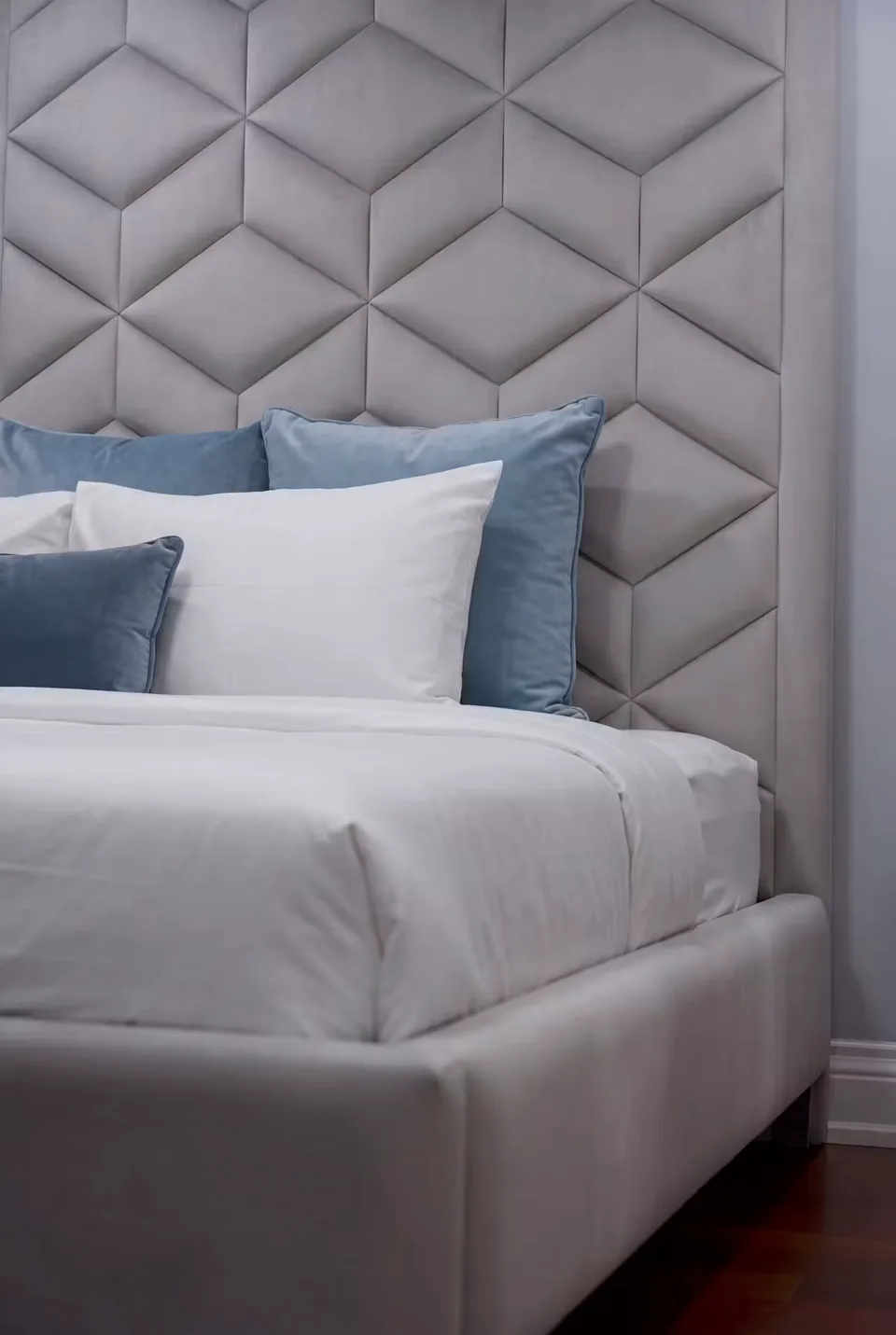 Detail of the padded diamond shapes behind blue accent pillows