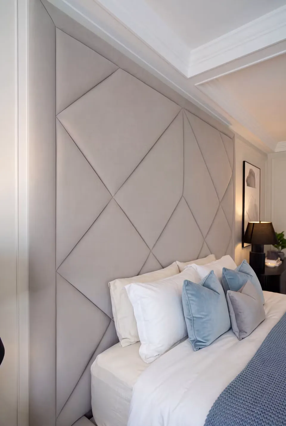 Close view of the silver diamond headboard and its straight padded border
