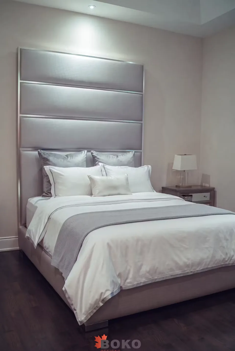 Angled view of the silver-grey upholstered frame and stacked padded headboard