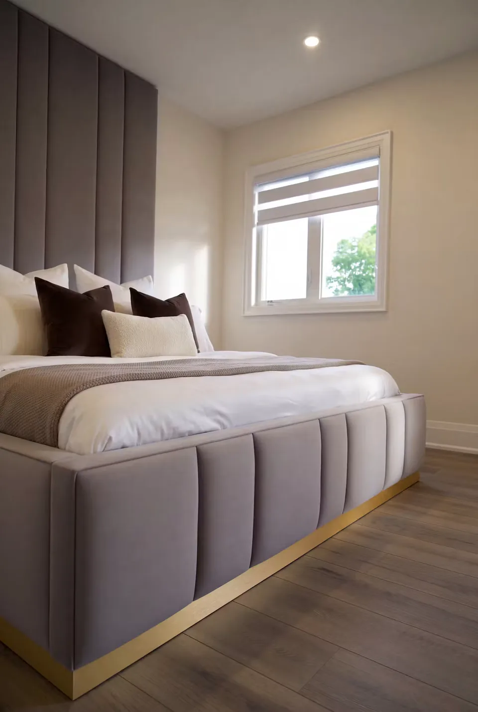 Detail of the grey channelled footboard, gold base and matching tall headboard.