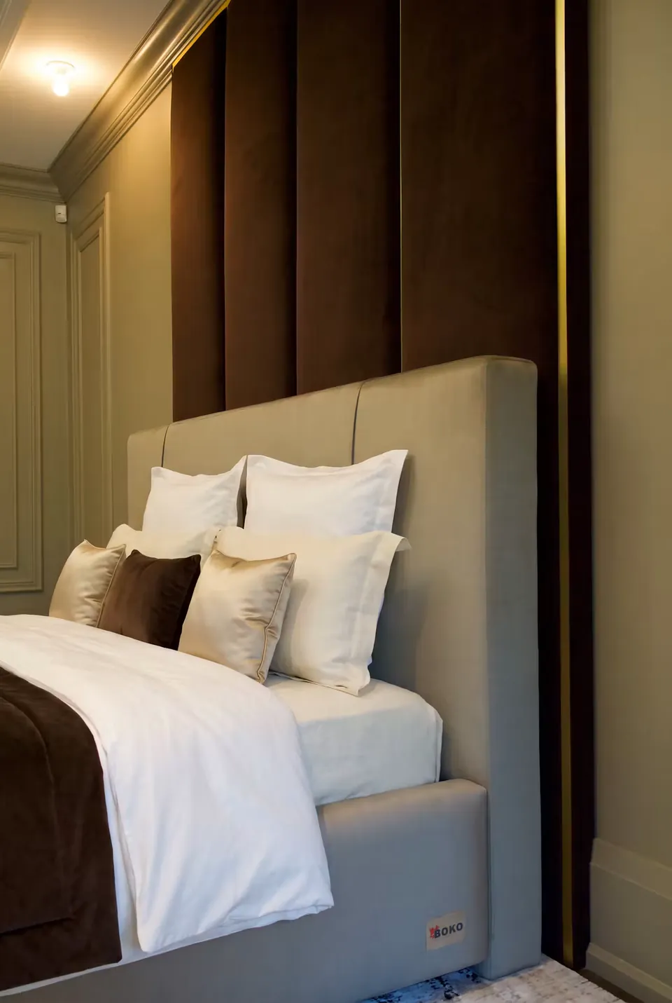 Close view of the plain slate headboard against the taller cocoa backdrop.