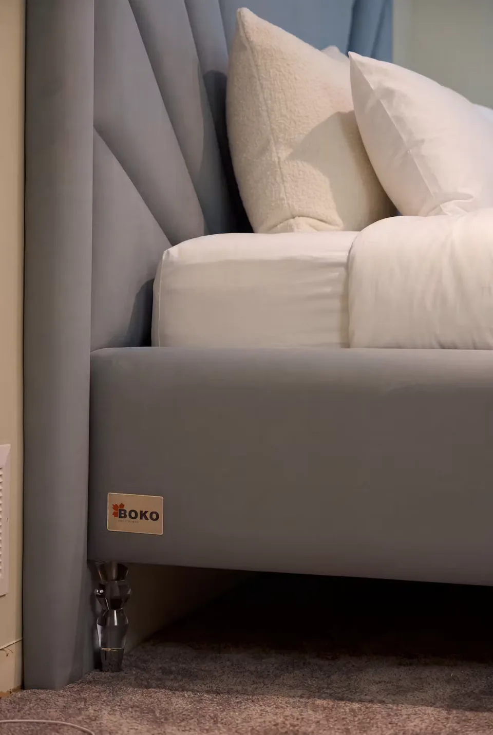 Detail of the upholstered side rail, BOKO label and clear foot