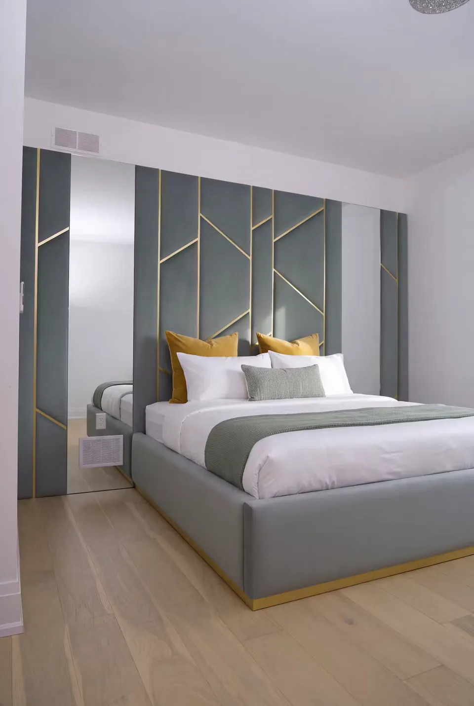 Angled view of the slate padded panels and gold-trimmed frame