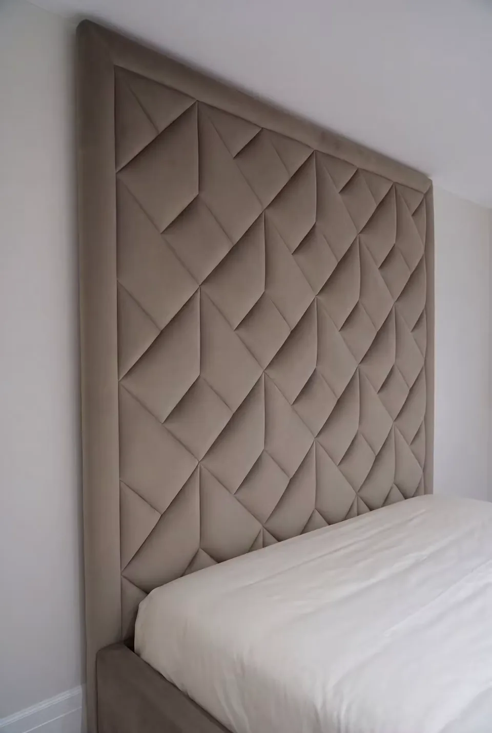 Close view of the diagonal taupe upholstery panels