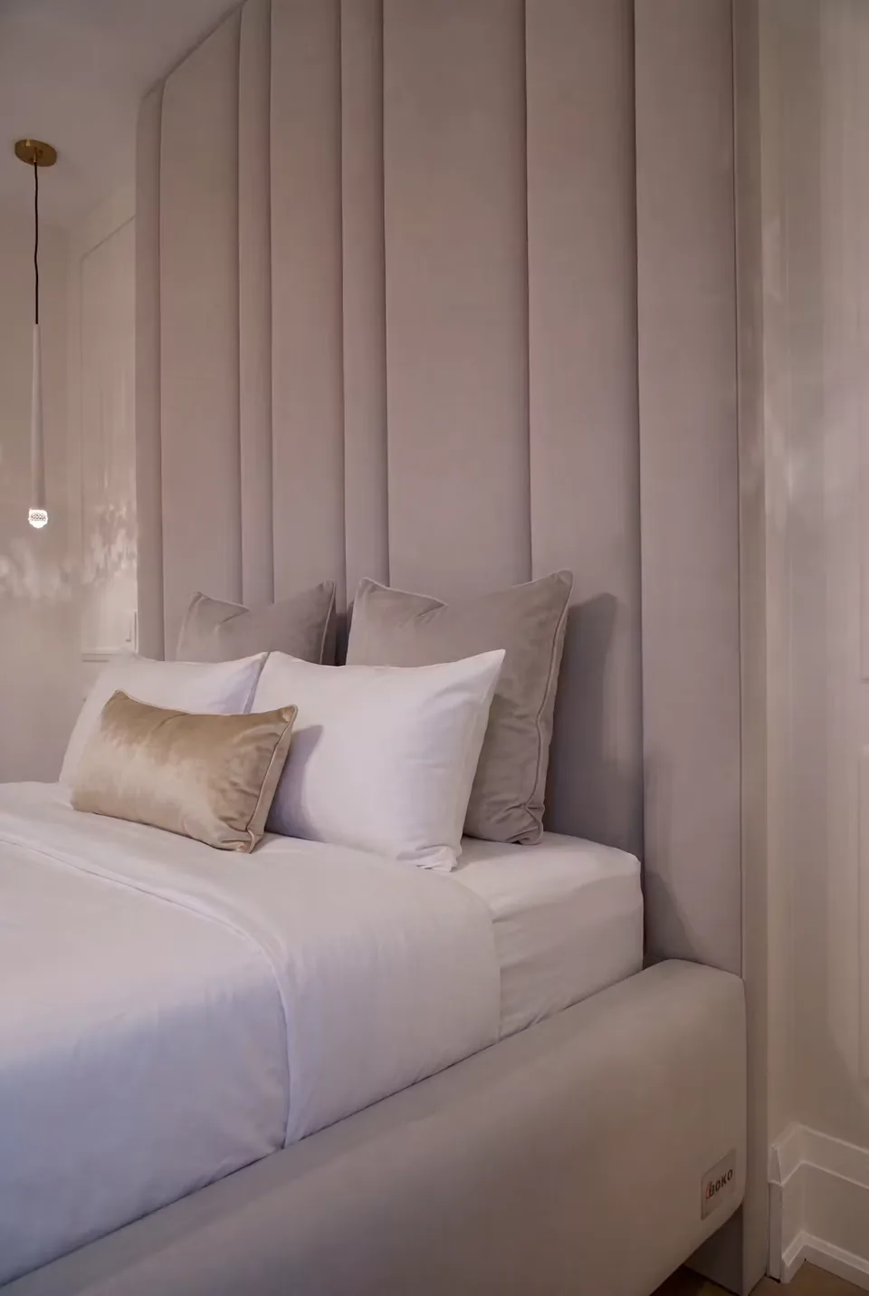 Detail of the taupe channel seams beside pale pillows