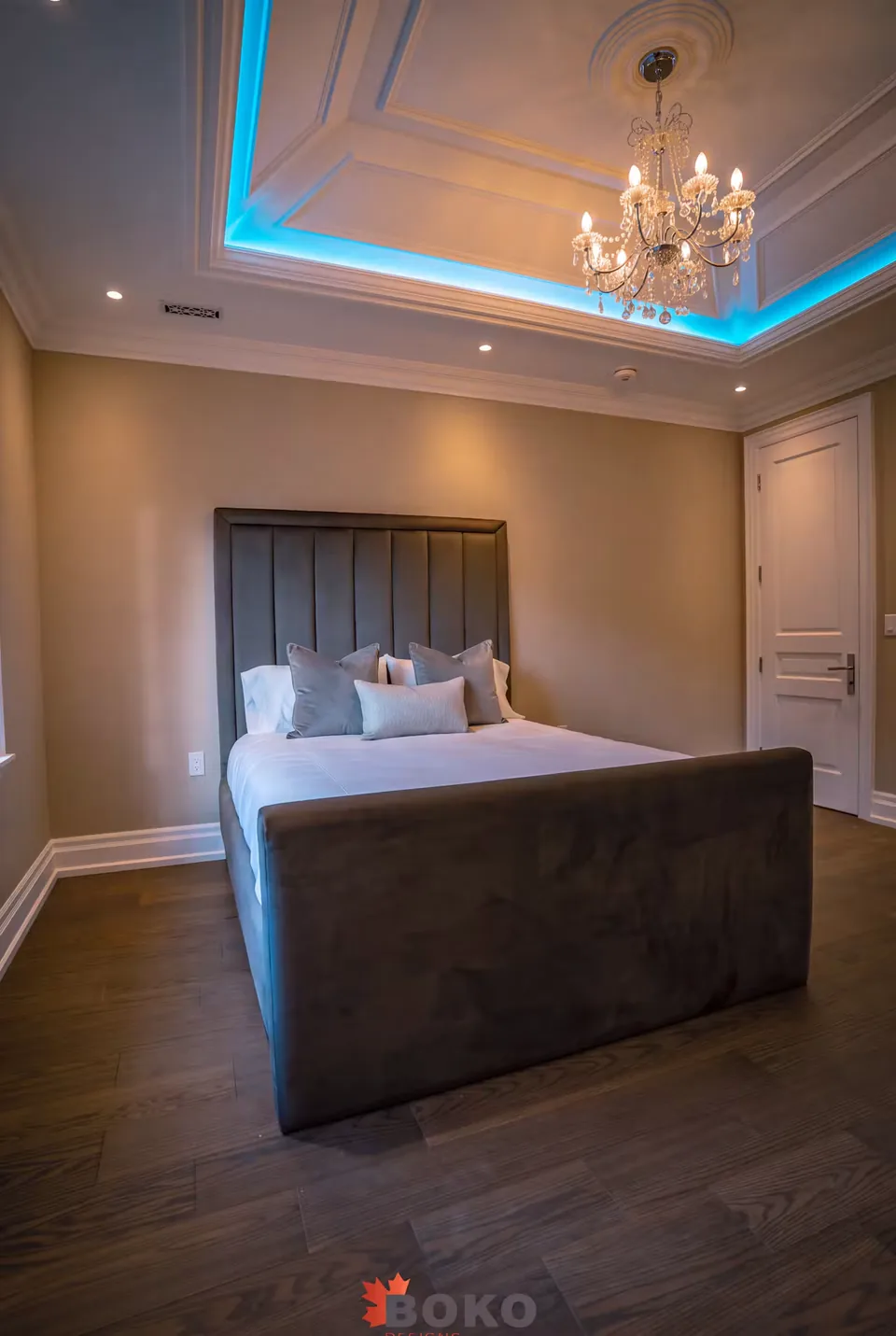 Front room view of the taupe padded frame beneath the ceiling light