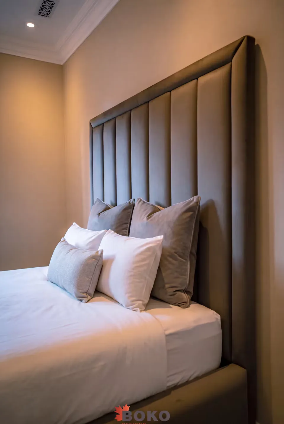Close view of the tall taupe channel headboard