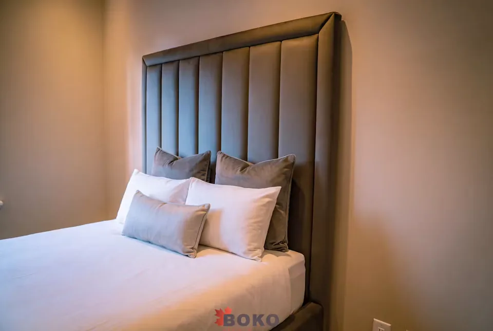Angled detail of the padded headboard border beside the pillows