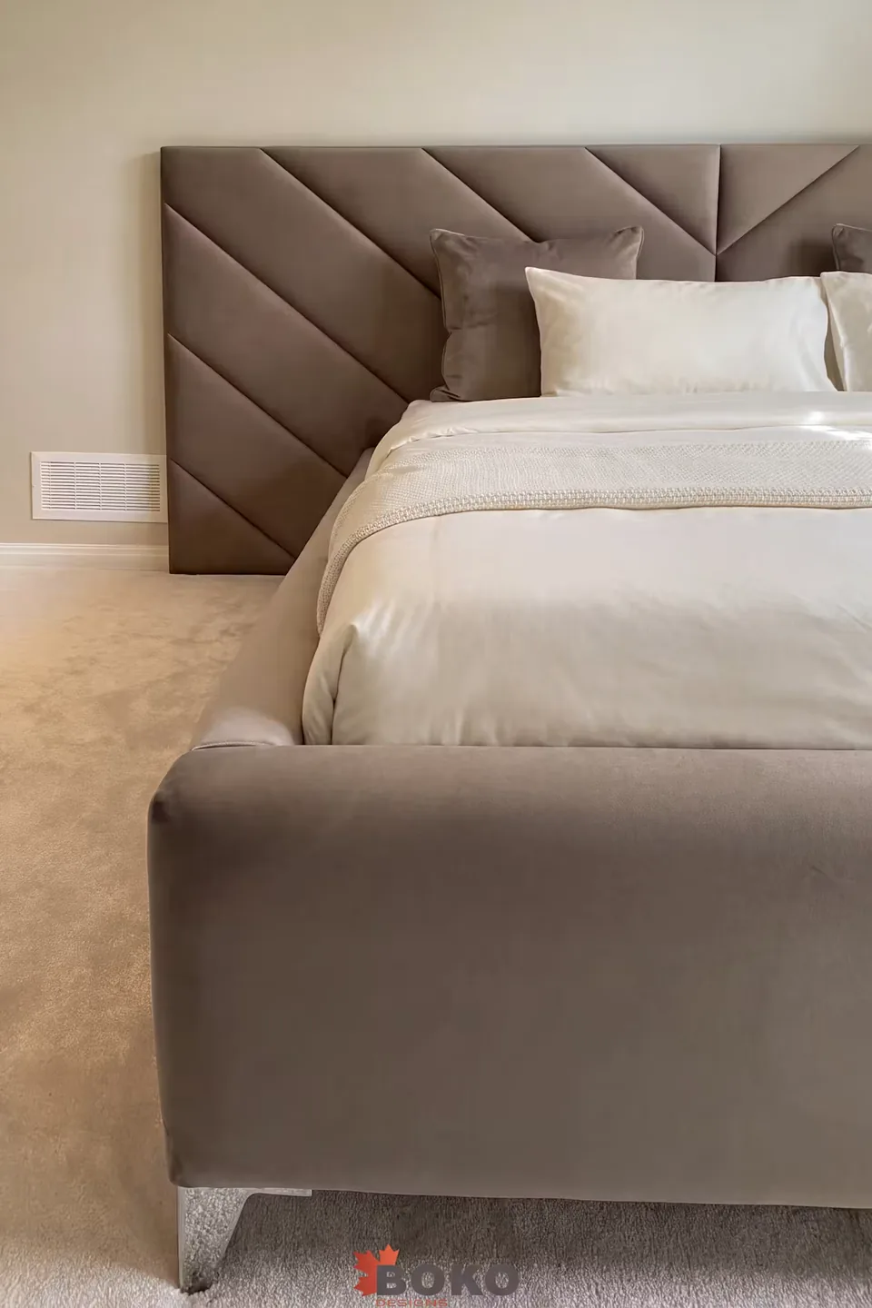 Portrait front angle of the taupe bed and diagonal upholstered headboard