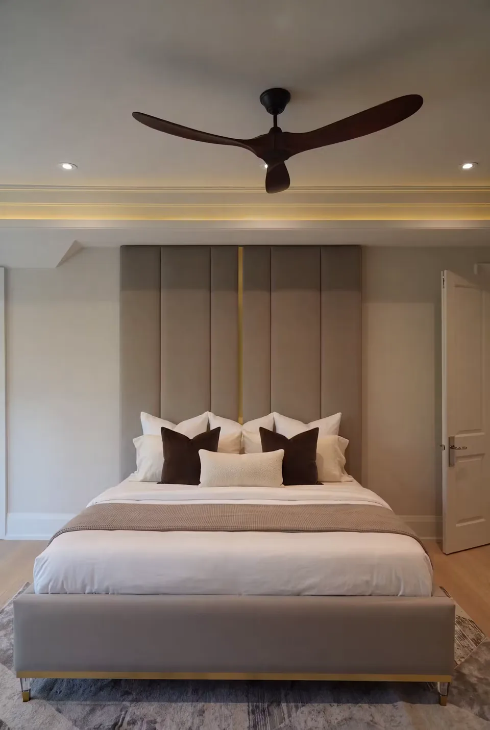 Front view of a taupe panelled bed with a narrow gold-toned vertical accent
