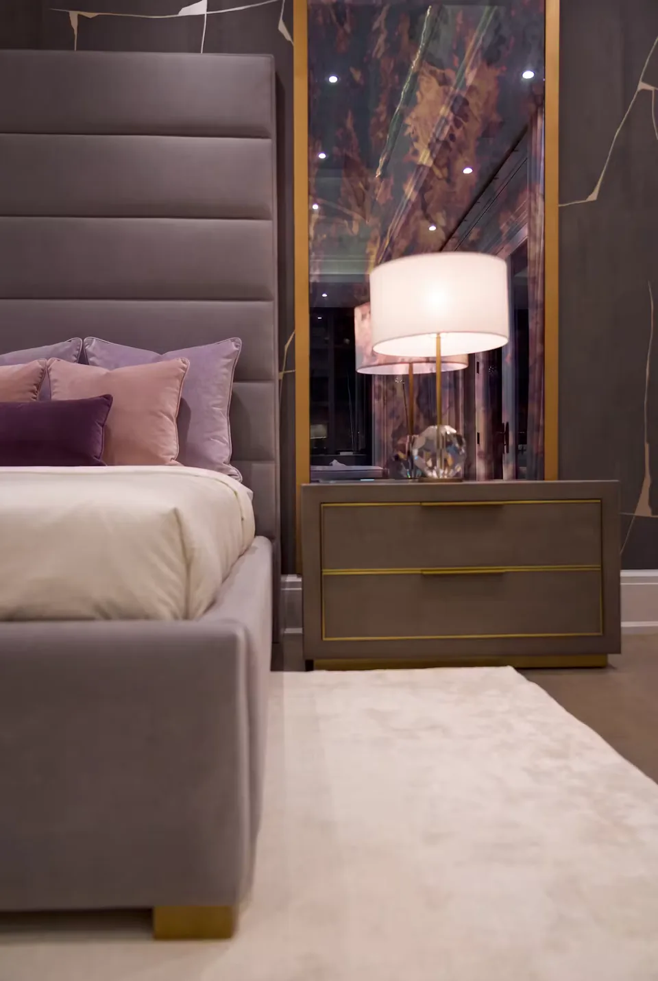 Detail of the taupe padded frame beside the bedside drawers