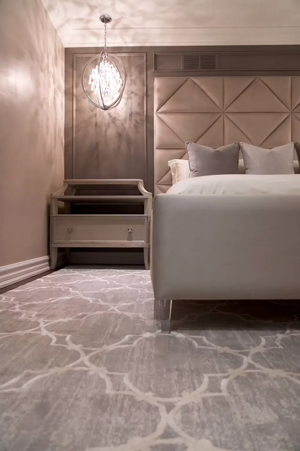 Portrait view of the taupe footboard and geometric headboard