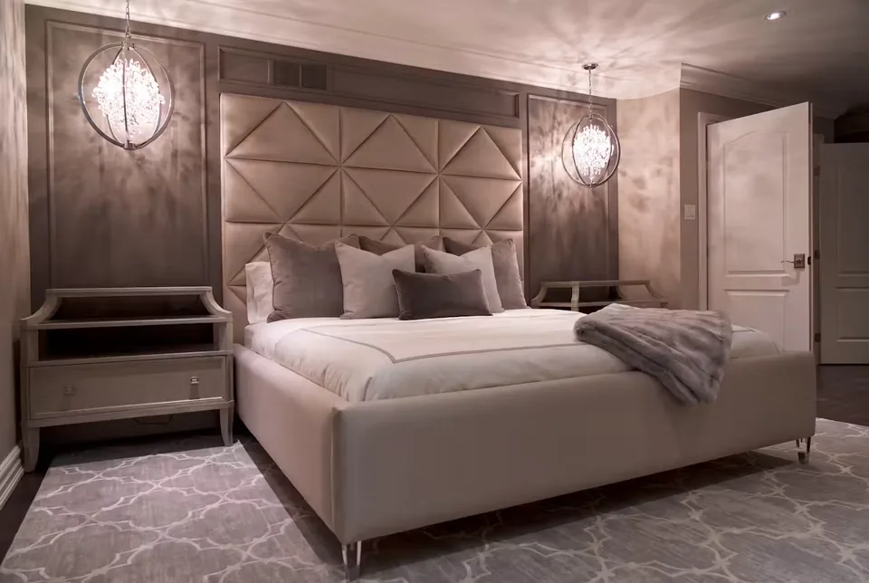 Wide room view of the taupe bed and matching padded wall
