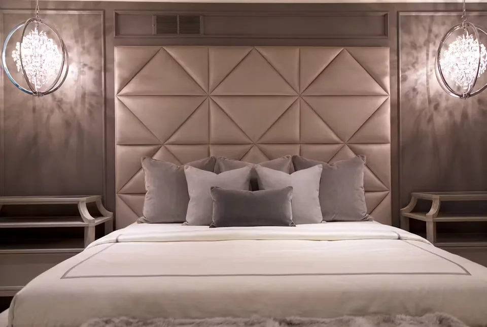 Closer front view of the triangular upholstery above the bedding