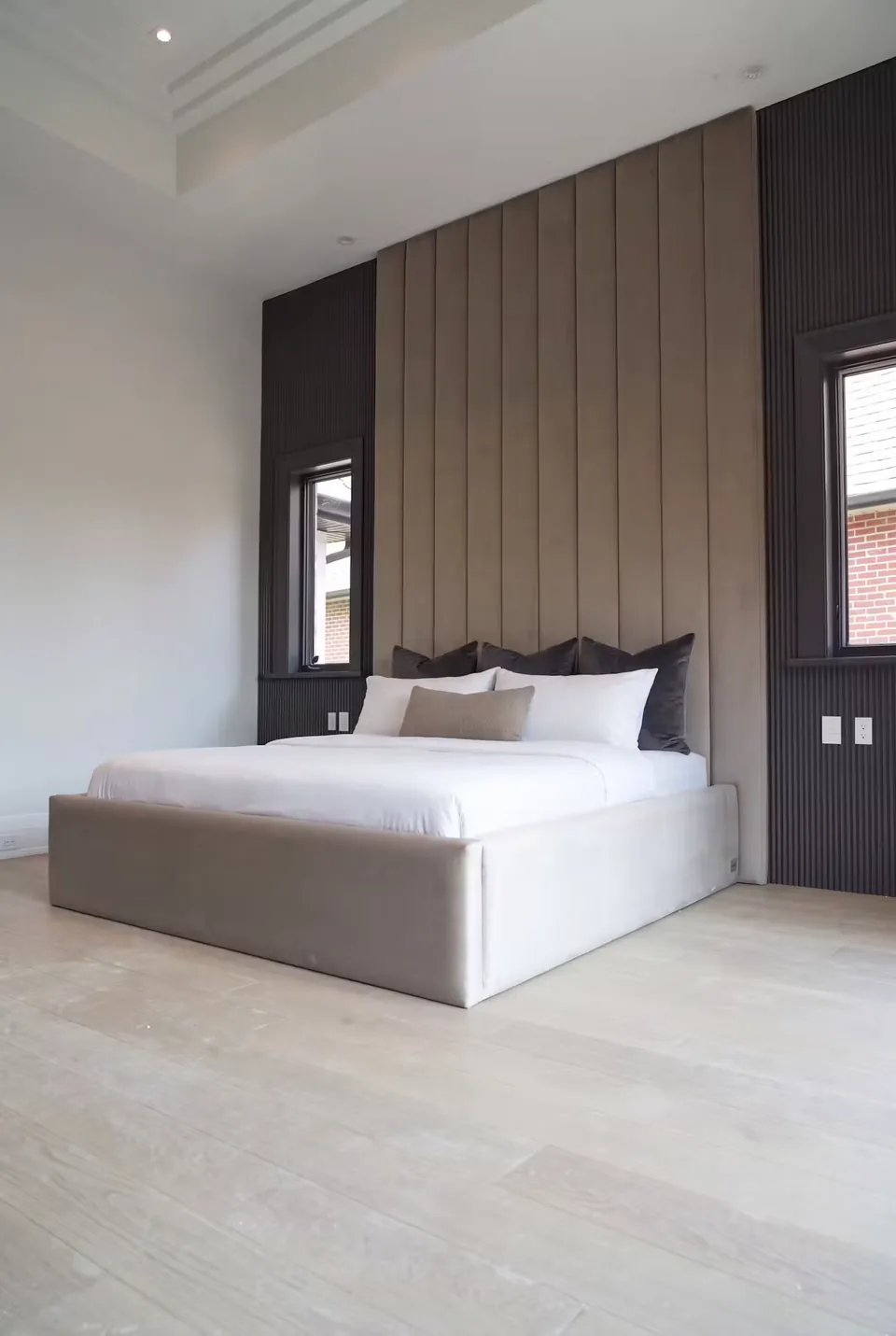 Angled view of the padded taupe frame between the windows