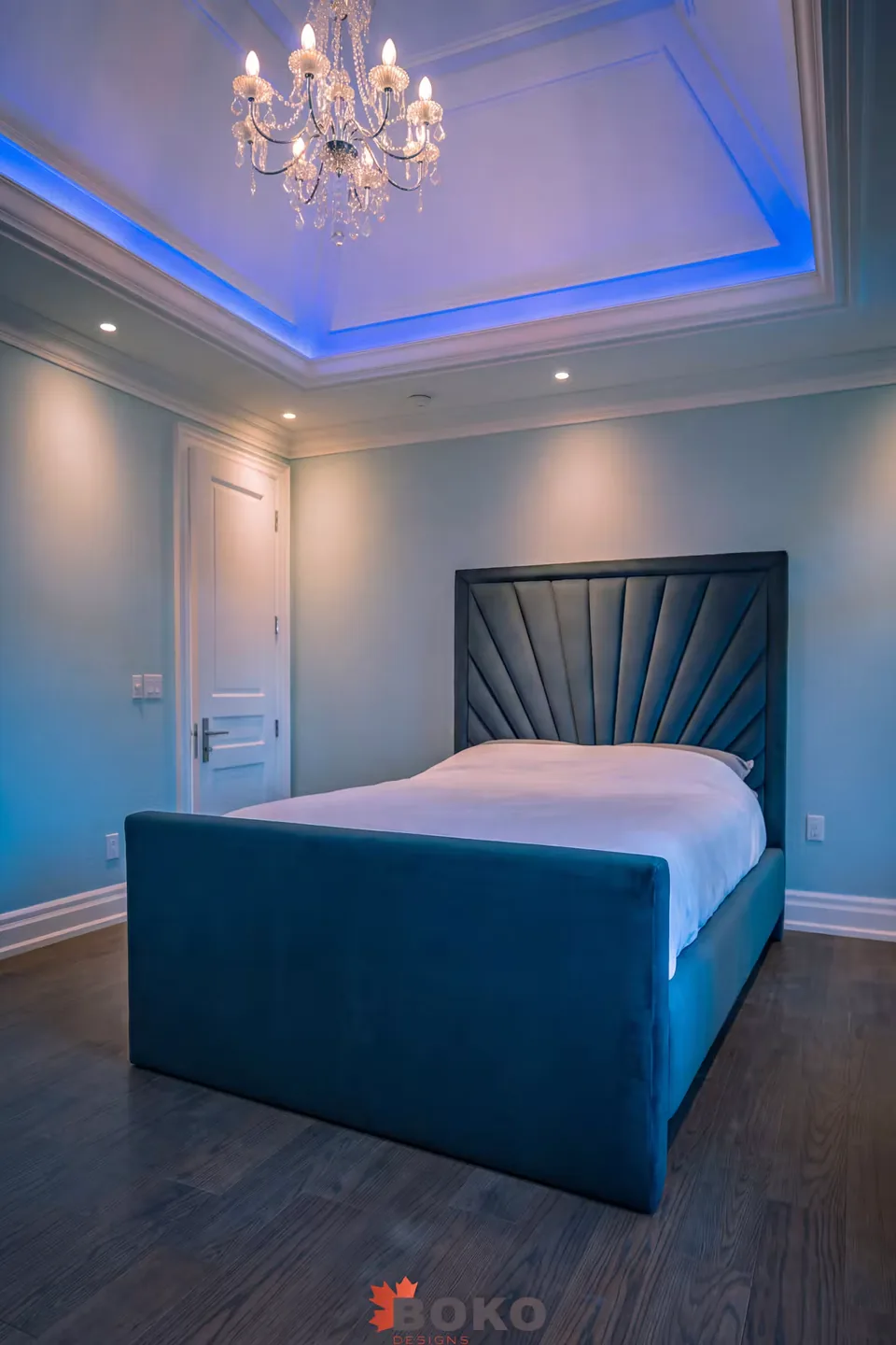 Full room view of the teal bed with framed fan headboard