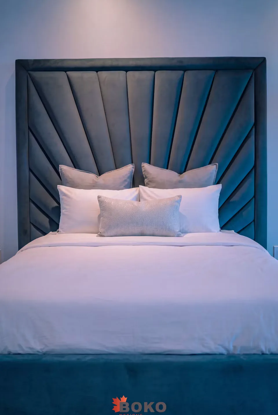 Front view of the teal headboard and padded footboard
