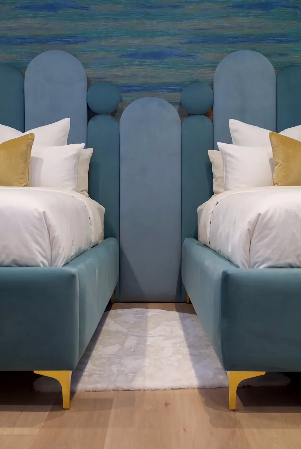 Detail of the rounded teal columns and circles between the two beds.