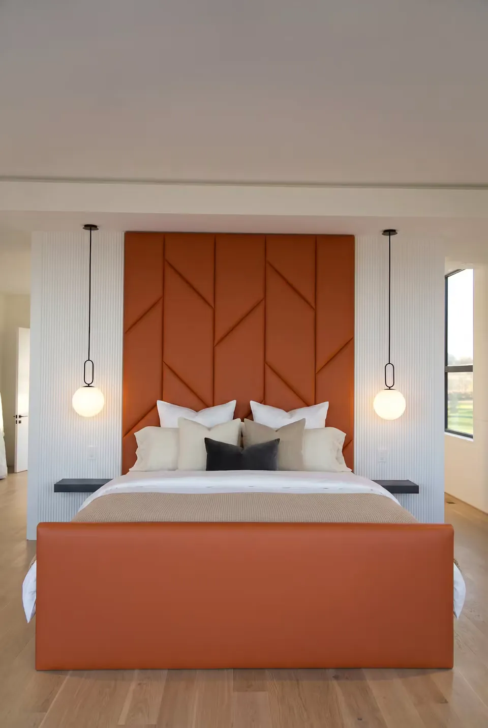 Front view of the terracotta bed between two hanging globe lights.