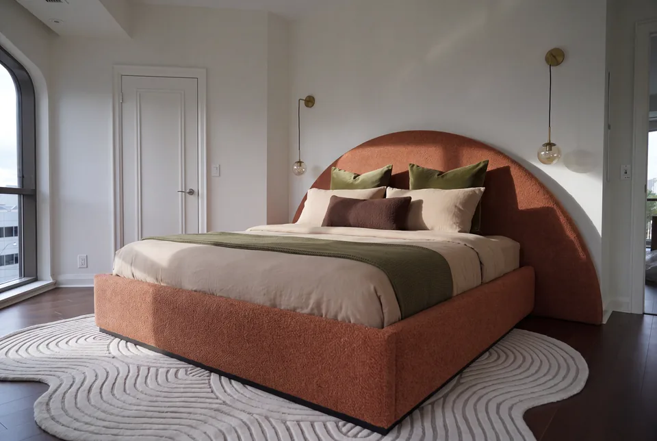Terracotta upholstered bed with a broad half-moon headboard